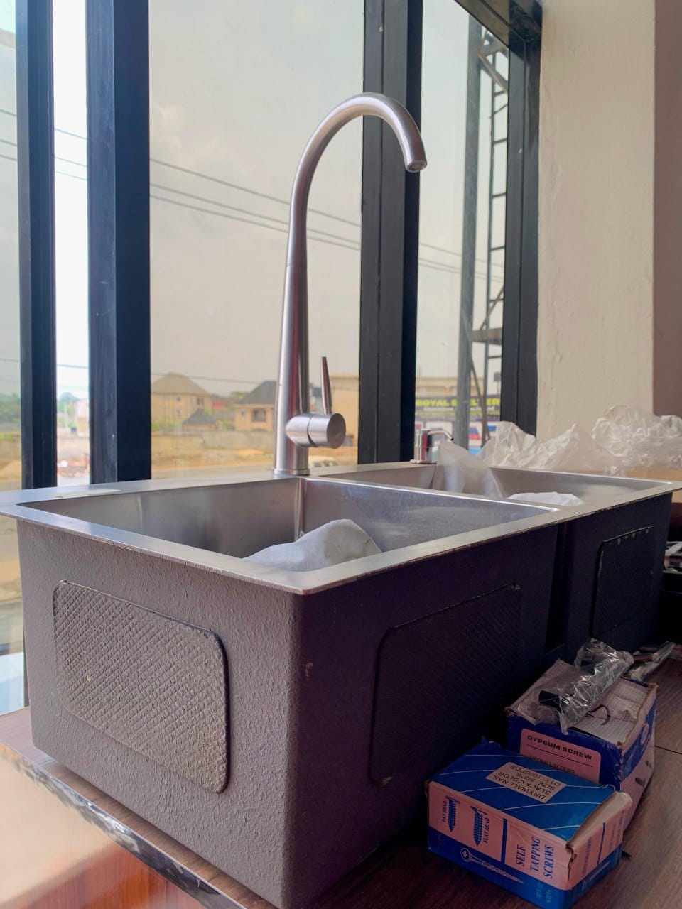 Modern double-bowl stainless steel kitchen sink with high-arc faucet